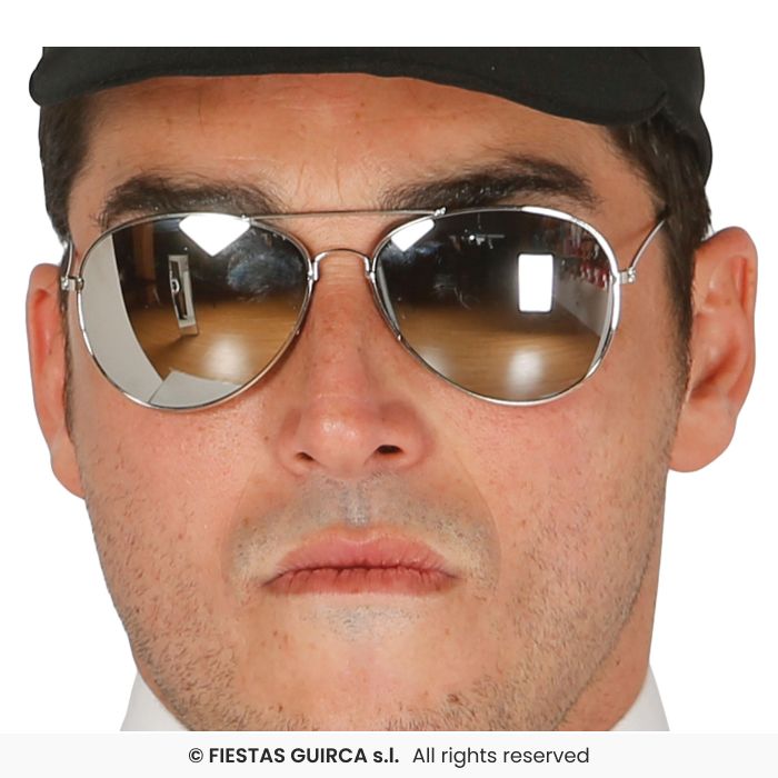 Close-up of a person wearing reflective aviator sunglasses with a black cap.